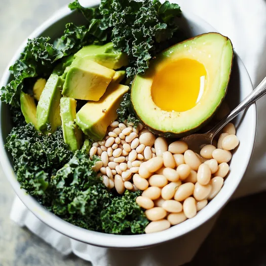 A bowl of food with avocado, beans, and kale.