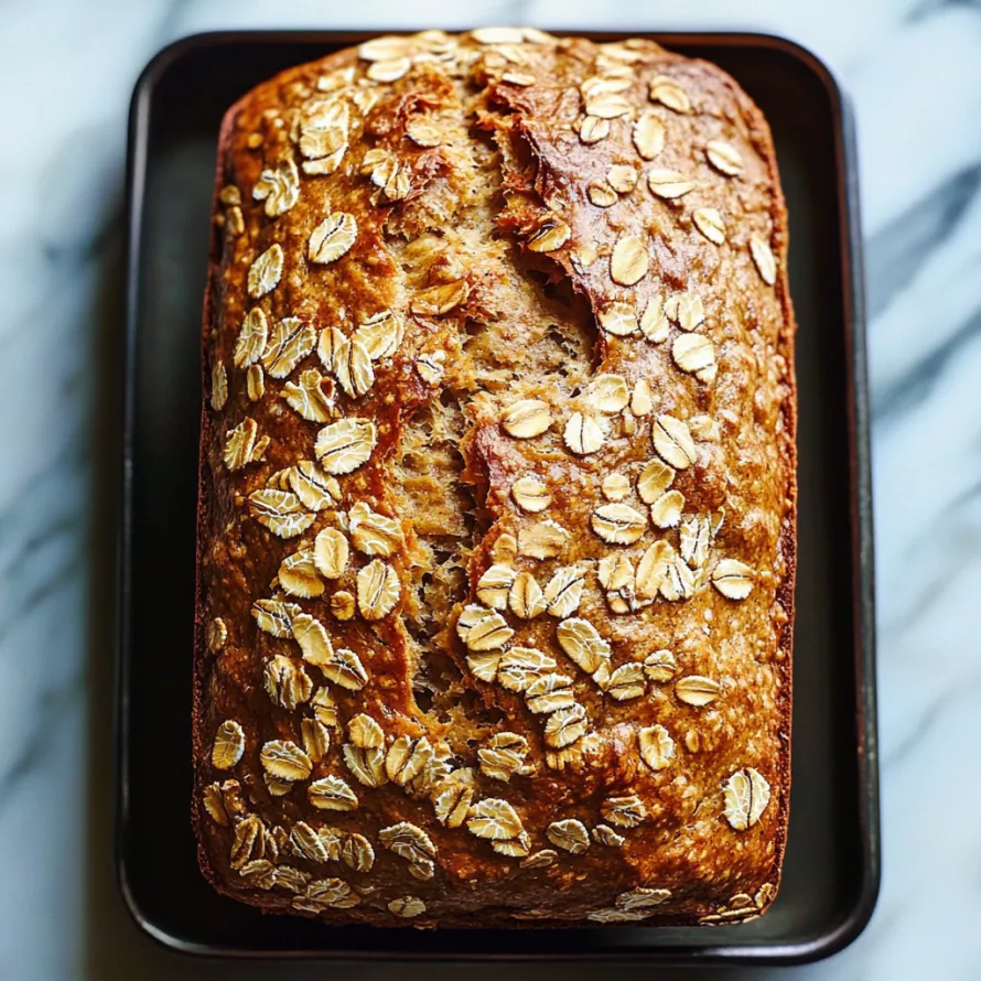 A loaf of bread with oats sprinkled on top.
