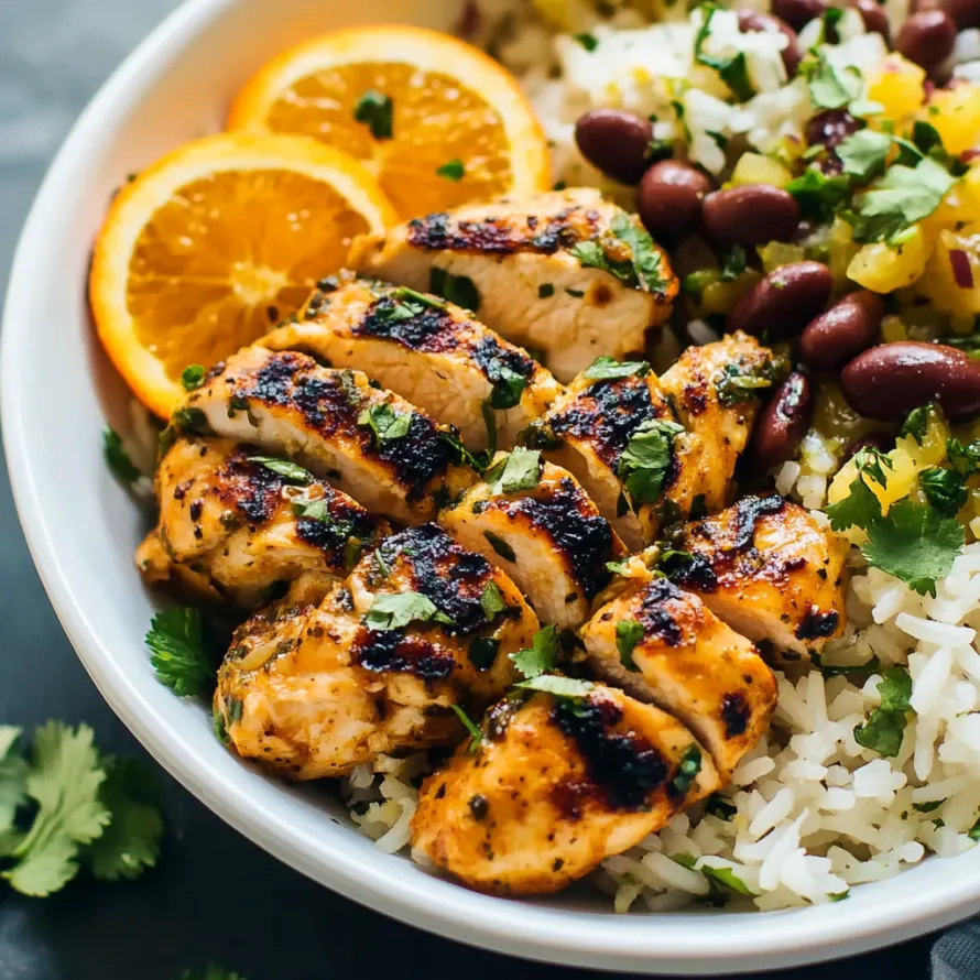 A bowl with rice, beans, and chicken.