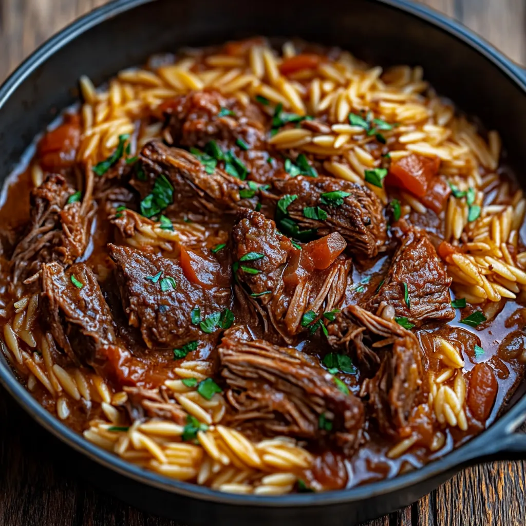 A black skillet filled with beef and rice, looking super tasty.