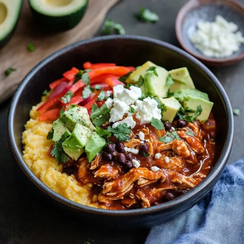 A delicious mix of chicken, beans, and avocado in a bowl.